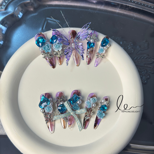 （Long-Length Almond-shaped）Handmade nail stickers, with purple-pink-yellow gradation, blue flower diamonds, and small silver diamond accents.