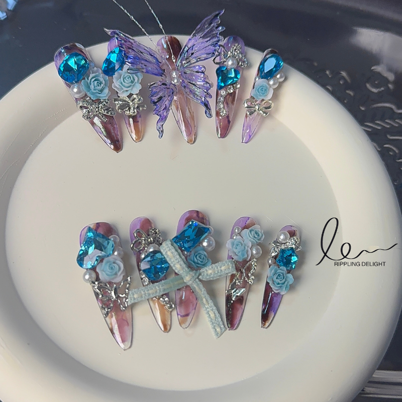 （Long-Length Almond-shaped）Handmade nail stickers, with purple-pink-yellow gradation, blue flower diamonds, and small silver diamond accents.